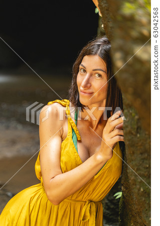 Positive delighted young beauty posing on camera 63042568