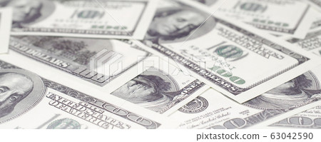 US dollars rolled up and tightened with band lies US dollars rolled up and tightened with band lies 63042590