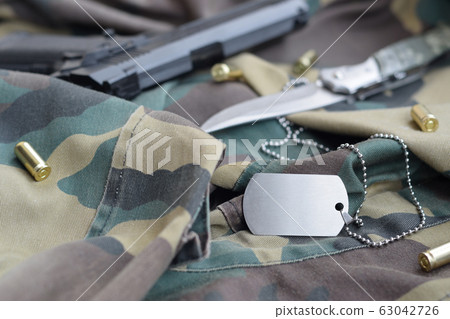 Army Dog tag token with 9mm bullets and pistol lie Army Dog tag token with 9mm bullets and pistol lie 63042726