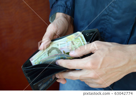 Close up male hands opened the wallet or purse 63042774