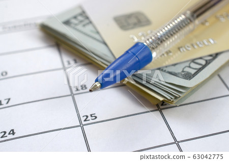 Pen and credit card on many hundred US dollar 63042775