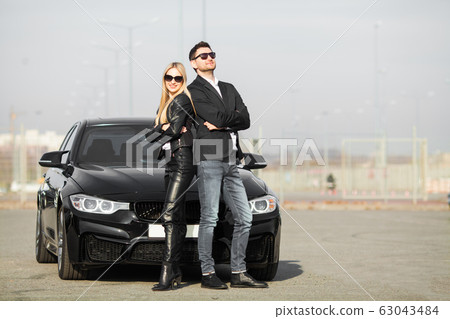 Happy young couple chooses and buying a new car for the family. Happy young couple chooses and buying a new car for the family. 63043484
