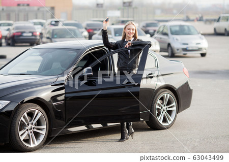 Young happy woman bought new modern car Young happy woman bought new modern car 63043499