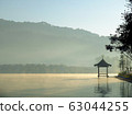 Beautiful scenery during sunrise with the water reflection of the small pavilion at the Lee Wine Ruk Thai lake, Mae Hong Son, north of Thailand. 63044255