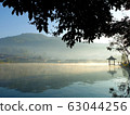 Beautiful scenery during sunrise with the water reflection of the small pavilion at the Lee Wine Ruk Thai lake, Mae Hong Son, north of Thailand. 63044256