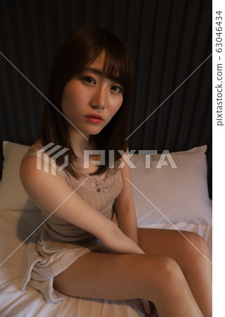 Daily, room wear of a female college student living alone in the city. The real face of a girl in her 20s relaxing in her bedroom. Daily, room wear of a female college student living alone in the city. The real face of a girl in her 20s relaxing in her bedroom. 63046434