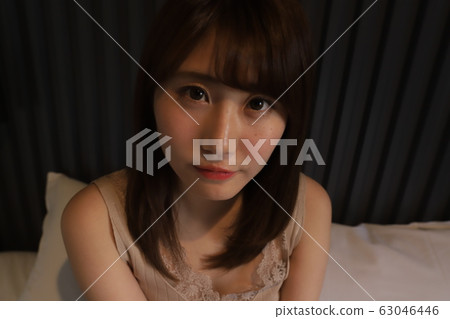 Daily, room wear of a female college student living alone in the city. The real face of a girl in her 20s relaxing in her bedroom. Daily, room wear of a female college student living alone in the city. The real face of a girl in her 20s relaxing in her bedroom. 63046446