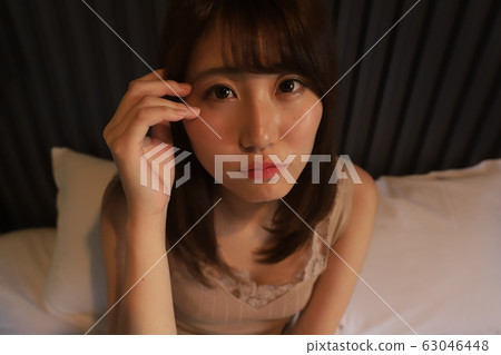 Daily, room wear of a female college student living alone in the city. The real face of a girl in her 20s relaxing in her bedroom. Daily, room wear of a female college student living alone in the city. The real face of a girl in her 20s relaxing in her bedroom. 63046448
