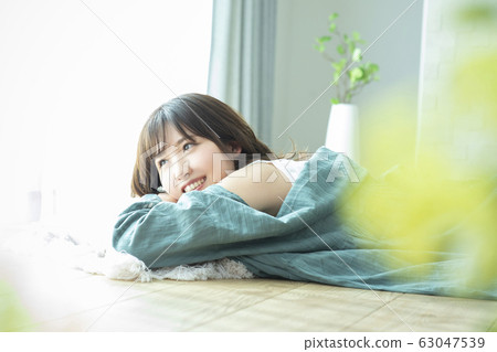 A young woman lying on the floor A young woman lying on the floor 63047539