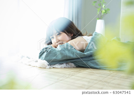 A young woman lying on the floor A young woman lying on the floor 63047541