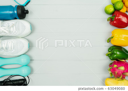 Healthy lifestyle, food and sport concept. athlete's equipment and fresh fruit on wooden background 63049080