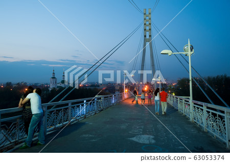 Lovers bridge in dusk time. Tyumen. Russia Lovers bridge in dusk time. Tyumen. Russia 63053374