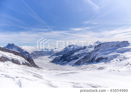 Great Aletsch glacier world heritage of Swiss and Bernese Alps and jungfrau snow mountain peak view from Jungfraujoch top of Europe with blue sky in summer background and copy space, Switzerland Great Aletsch glacier world heritage of Swiss and Bernese Alps and jungfrau snow mountain peak view from Jungfraujoch top of Europe with blue sky in summer background and copy space, Switzerland 63054980