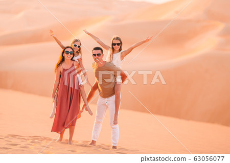People among dunes in Rub al-Khali desert in United Arab Emirates 63056077