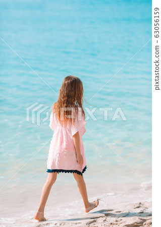 Adorable little girl have fun at tropical beach during vacation 63056159