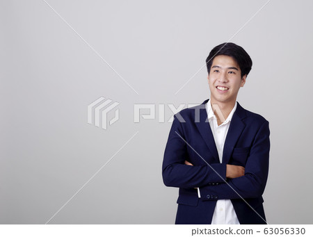 Young Asian businessman on white 63056330