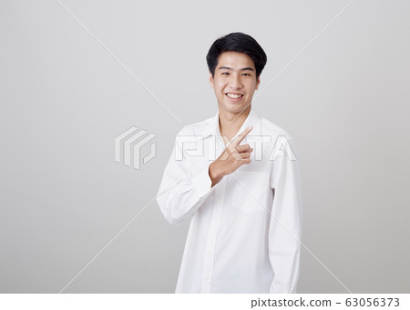 young asian handsome businessman on wall young asian handsome businessman on wall 63056373