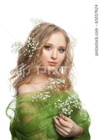 Cute young woman with flowers and healthy hair 63057624