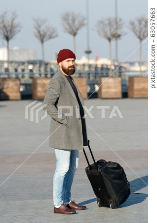 Man bearded hipster travel with big luggage bag on Man bearded hipster travel with big luggage bag on 63057663