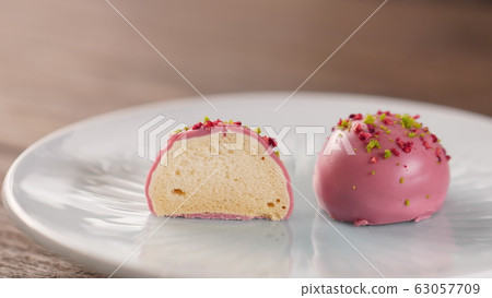 Baked meringue coated with ruby chocolate 63057709