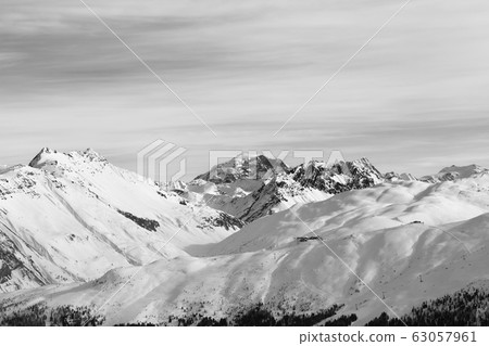 Snowy slope in high winter mountains and sunlit 63057961