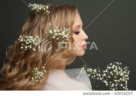Pretty female profile with white flowers on black 63058207