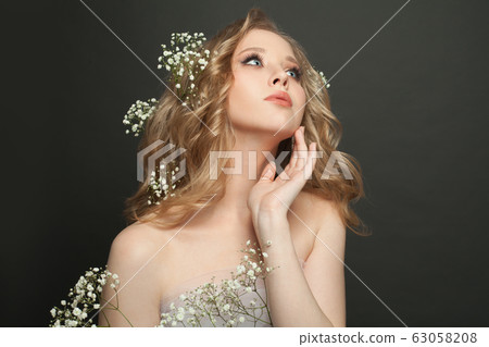 Nice woman with healthy curly hairdo and spring 63058208