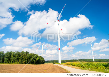 Turbines on field on cloudy blue sky Turbines on field on cloudy blue sky 63060337