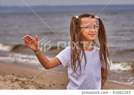 Portrait of a teenage girl in glasses and a white Portrait of a teenage girl in glasses and a white 63062265