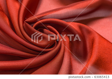 Shiny red cloth background dark curly background Shiny red cloth background dark curly background 63065413
