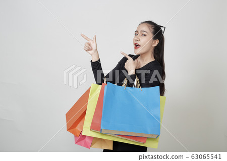 Happy Woman with Shopping Bags White Background 63065541