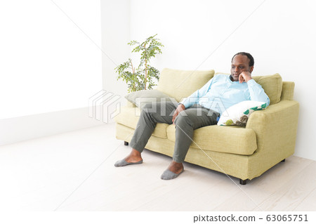 Black business man relaxing at home Black business man relaxing at home 63065751