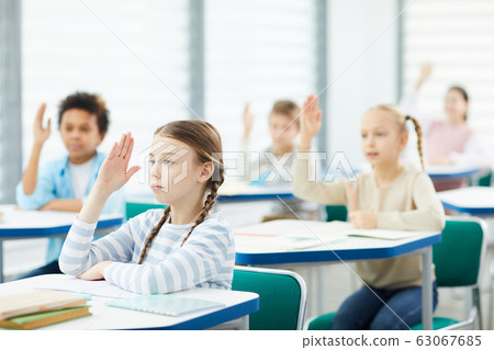 Students Raising Hands In Class 63067685