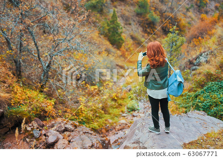 Female hiker taking selfie in mountains forest. 63067771