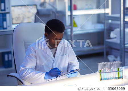 Male Laboratory Scientist Making Notes Male Laboratory Scientist Making Notes 63068069