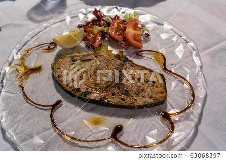 King mackerel steak with salad and tomato King mackerel steak with salad and tomato 63068397