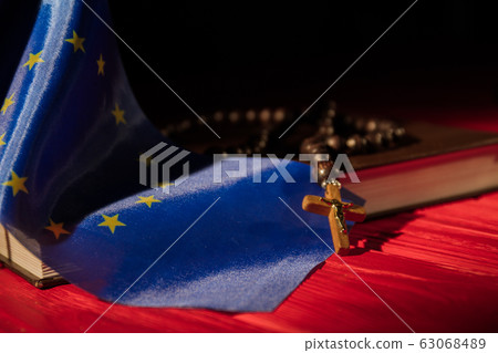 European Union flag, holy bible and rosary with crucifix. European Union flag, holy bible and rosary with crucifix. 63068489