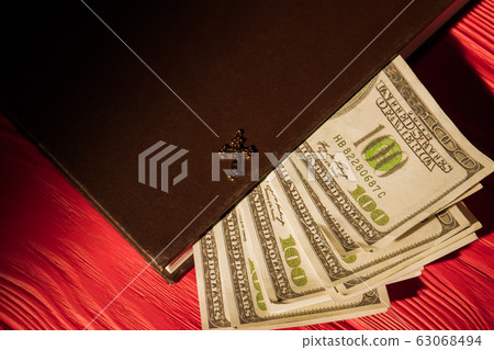 Money, holy bible and golden cross. 63068494