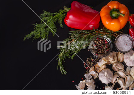 Herbs and multi-colour peppers. 63068954