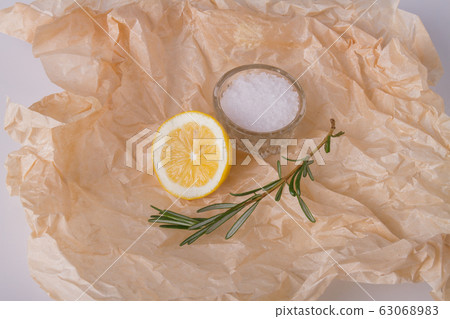 Rosemary, lemon and salt on kraft paper. 63068983
