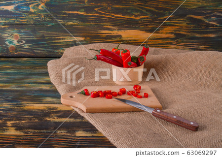Wooden plate with chili peppers. 63069297