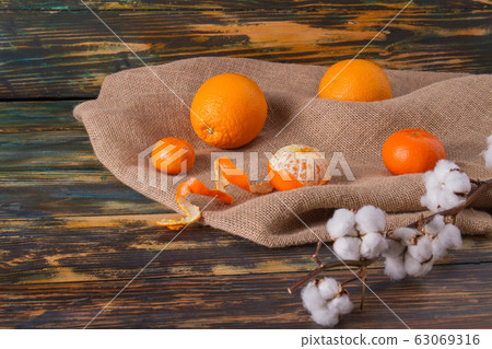 Orange citric fruits and a twig of cotton. 63069316