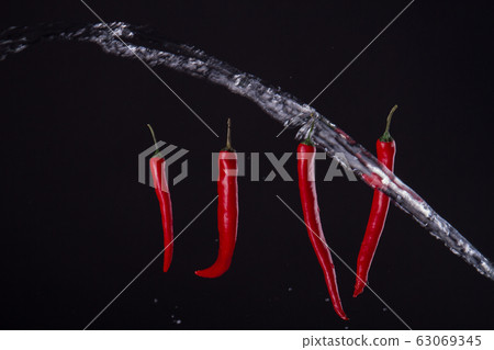 Four peppers with stream of water. Four peppers with stream of water. 63069345