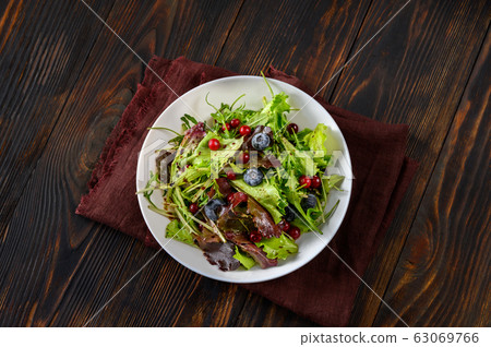 Bowl of fresh lettuce with berries Bowl of fresh lettuce with berries 63069766