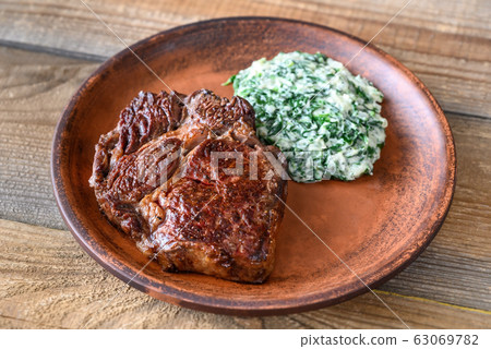 Beef steak with creamy spinach Beef steak with creamy spinach 63069782