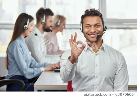 Indian call center agent shows ok gesture. 63070606