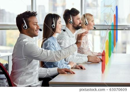 Black indian man working with diagrams on virtual display. 63070609