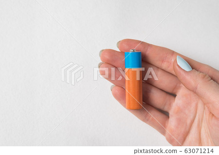 Generic accumulator lies in women's hand. AA Generic accumulator lies in women's hand. AA 63071214