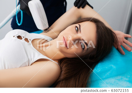 Woman getting laser treatment in a beauty salon. 63072155
