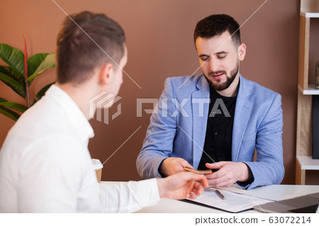 Man offers bribe an employee of the company Man offers bribe an employee of the company 63072214